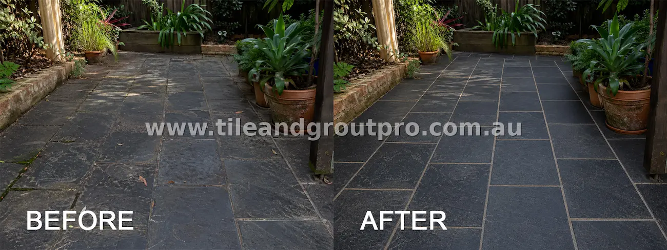 Dark slate outdoor patio tiles with dirt buildup, weathering, and stained grout before tile and grout cleaning
