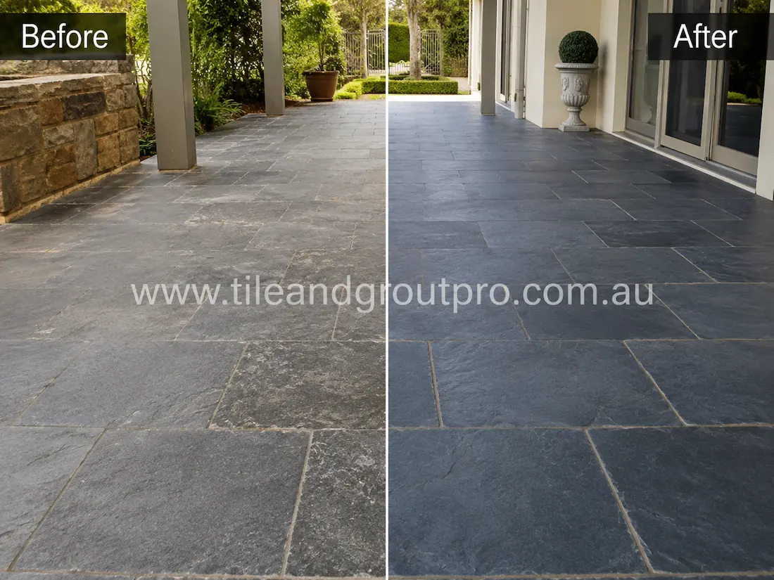 Before tile renewal, the outdoor bluestone patio tiles appeared faded and weathered with surface haze, uneven colouring, and worn natural stone texture in a covered alfresco area.