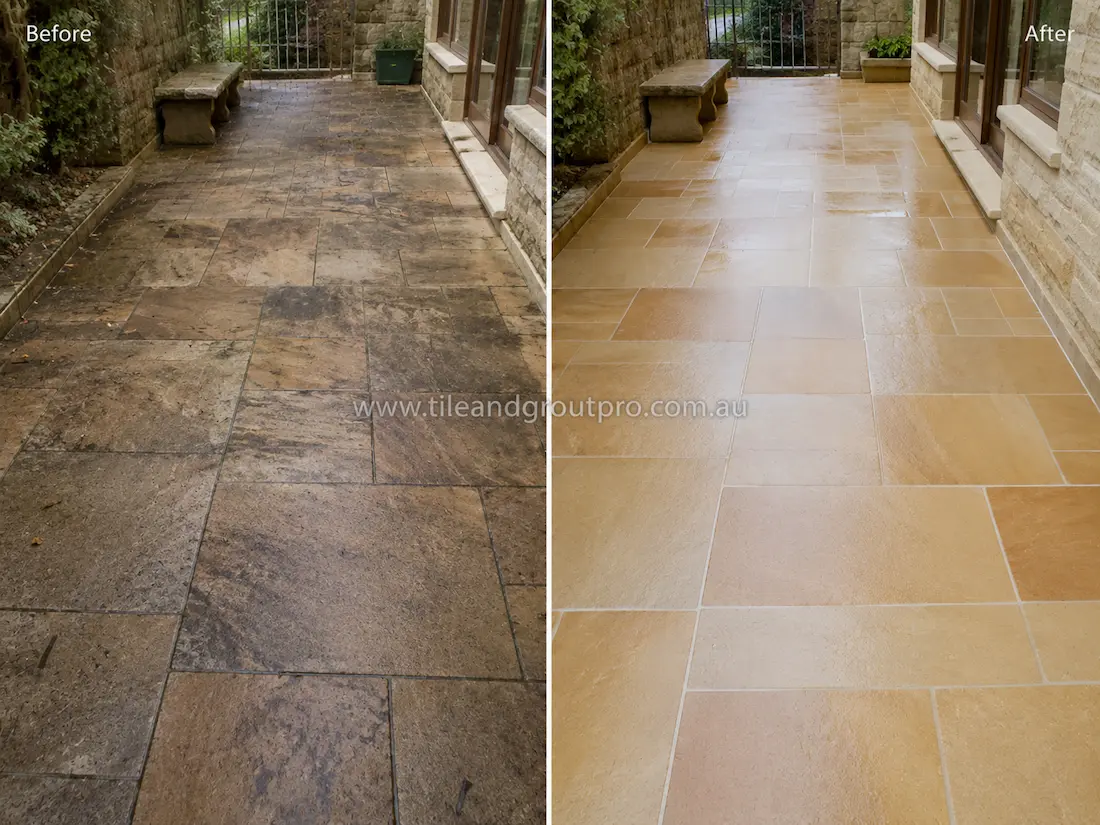 Before tile renewal, the outdoor sandstone patio tiles were heavily stained with dirt, moisture marks, and discoloration in a covered garden courtyard area.