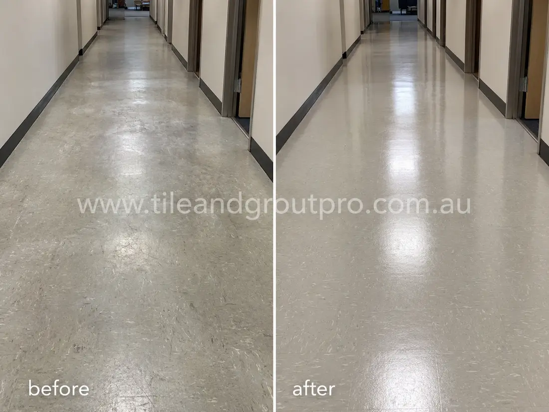 Office hallway with light grey linoleum floors before sealer stripping, showing traffic wear, scratches, dull sealer buildup, and uneven shine throughout the corridor.
