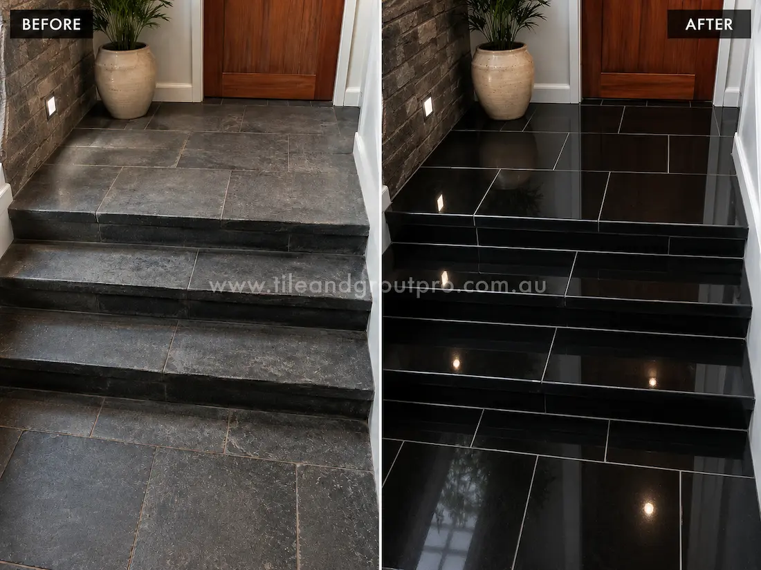 Before stone polishing, the black bluestone staircase and landing tiles looked worn and low-gloss with visible scuffs beside a timber door and stone feature wall.