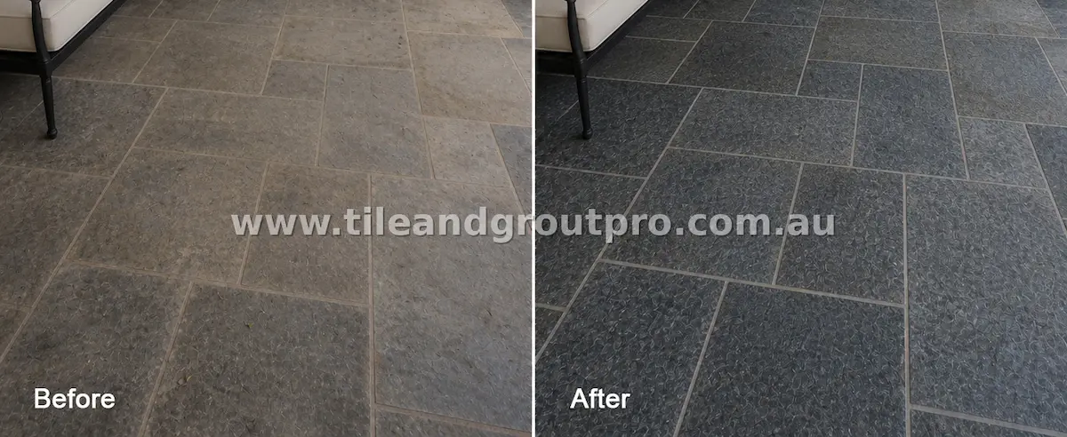 Close-up of textured bluestone floor tiles with embedded dirt, surface wear, and uneven coloration before tile and grout cleaning