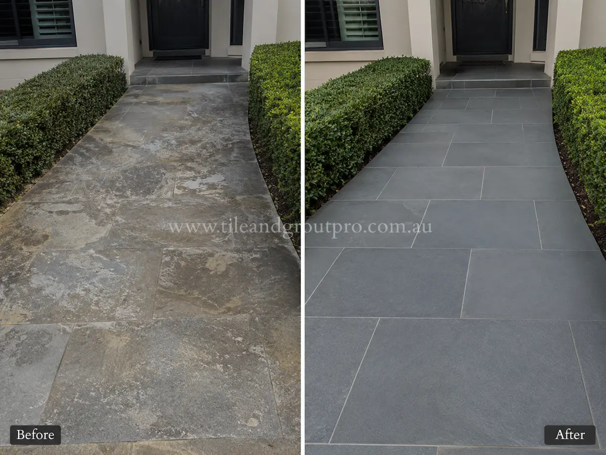Curved bluestone poolside paving before sealer stripping with white sealer staining and dull natural stone tiles beside a residential swimming pool.