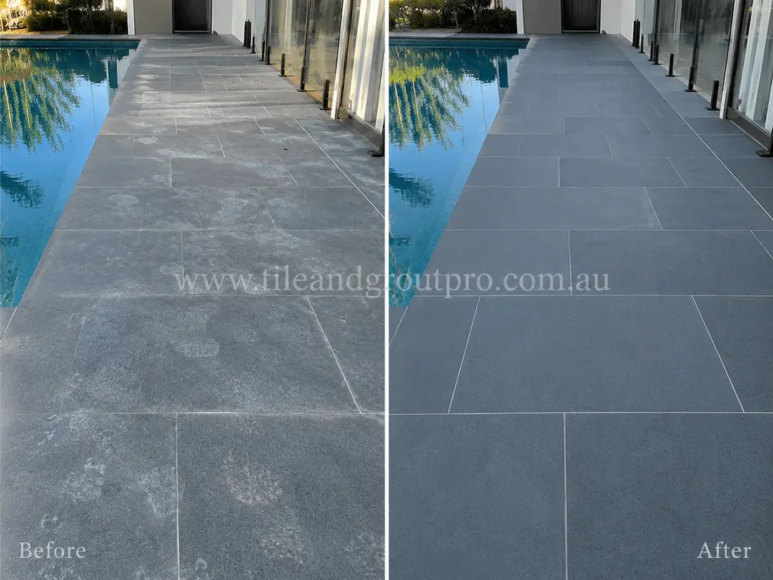 Outdoor poolside bluestone walkway with visible mineral staining, weather exposure, and faded surface finish before bluestone tile resurfacing and sealing.