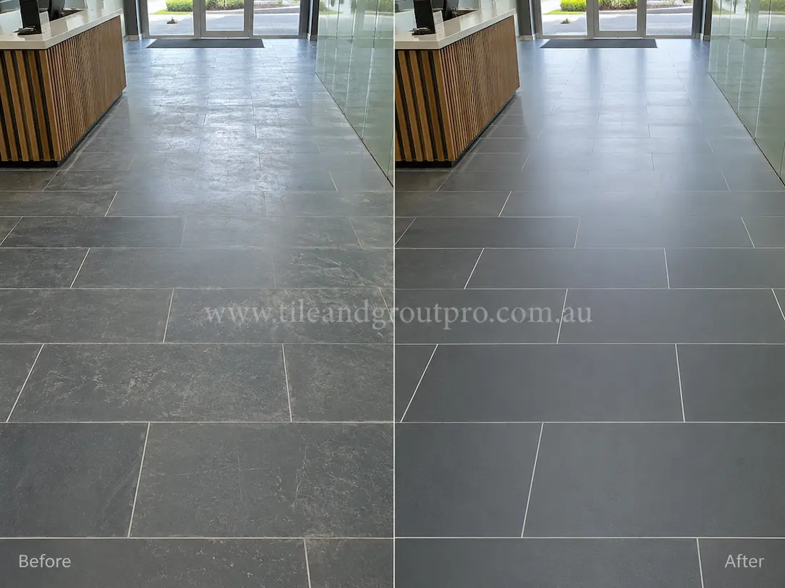 Commercial lobby floor with large-format bluestone tiles displaying worn finish, surface scratches, and dull appearance before bluestone tile resurfacing.