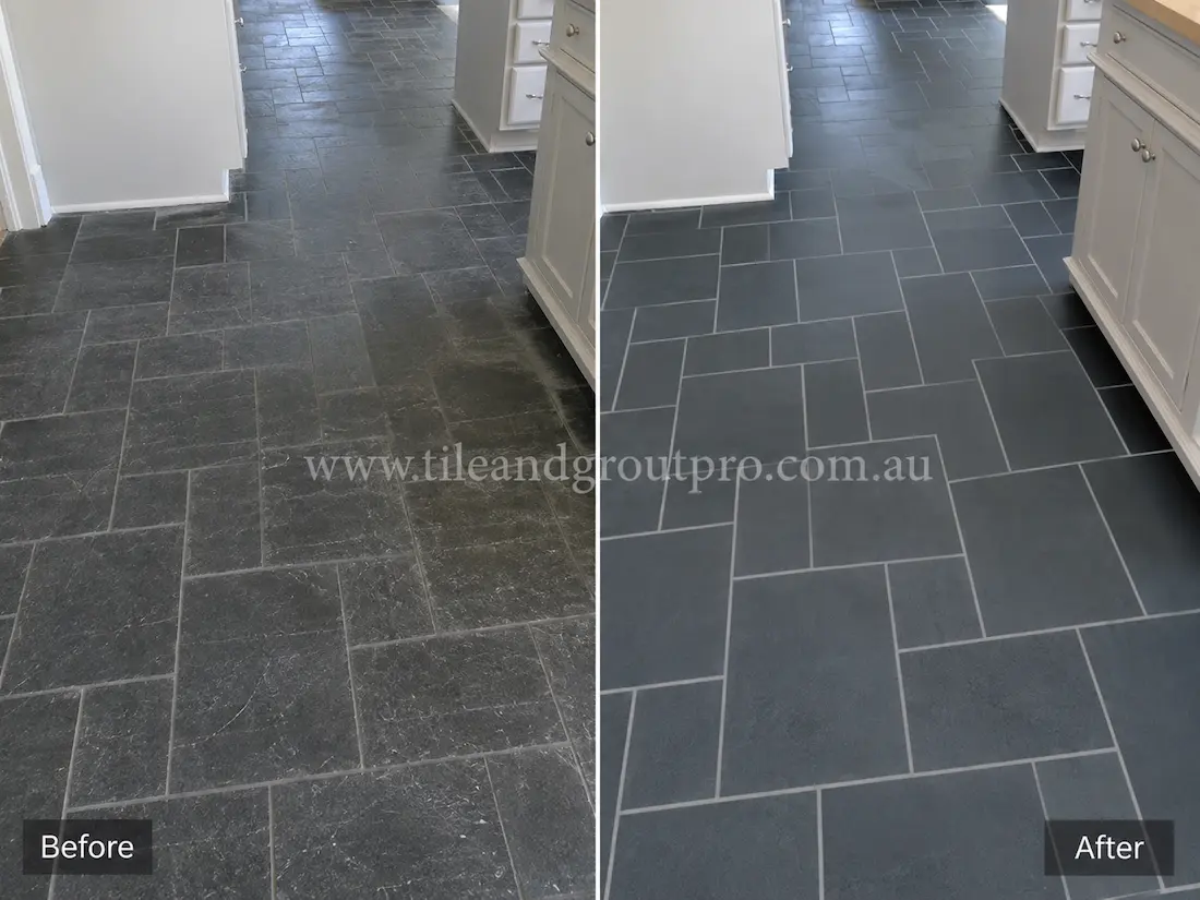 Residential kitchen floor with blue-grey bluestone tiles showing scratches, wear marks, and a faded finish before bluestone tile resurfacing.
