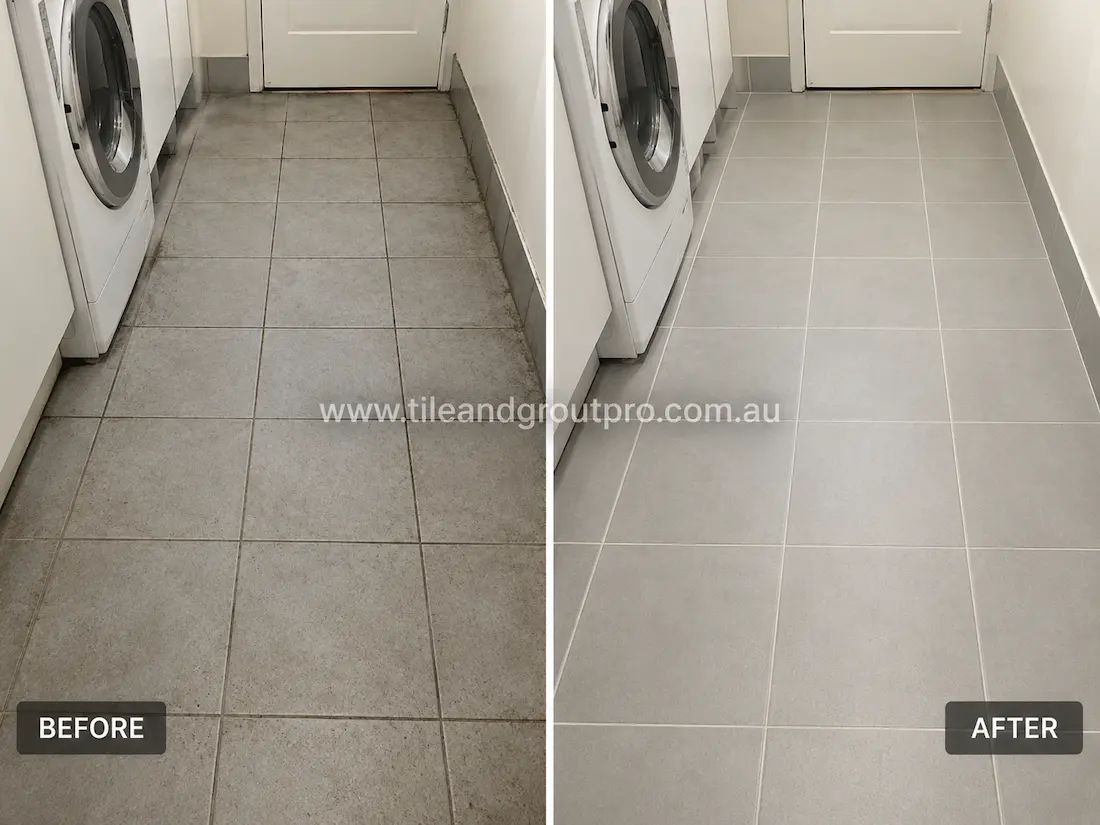 Before tile renewal, a laundry floor with light grey ceramic tiles exhibited dirty grout lines, surface staining, and accumulated grime along edges and appliance bases, reducing the overall cleanliness of the space.