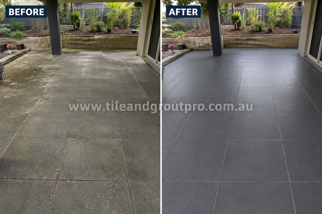 Dark grey concrete pavers in a covered outdoor patio area with surface grime, moisture staining, and biological growth before Tile Renewal.