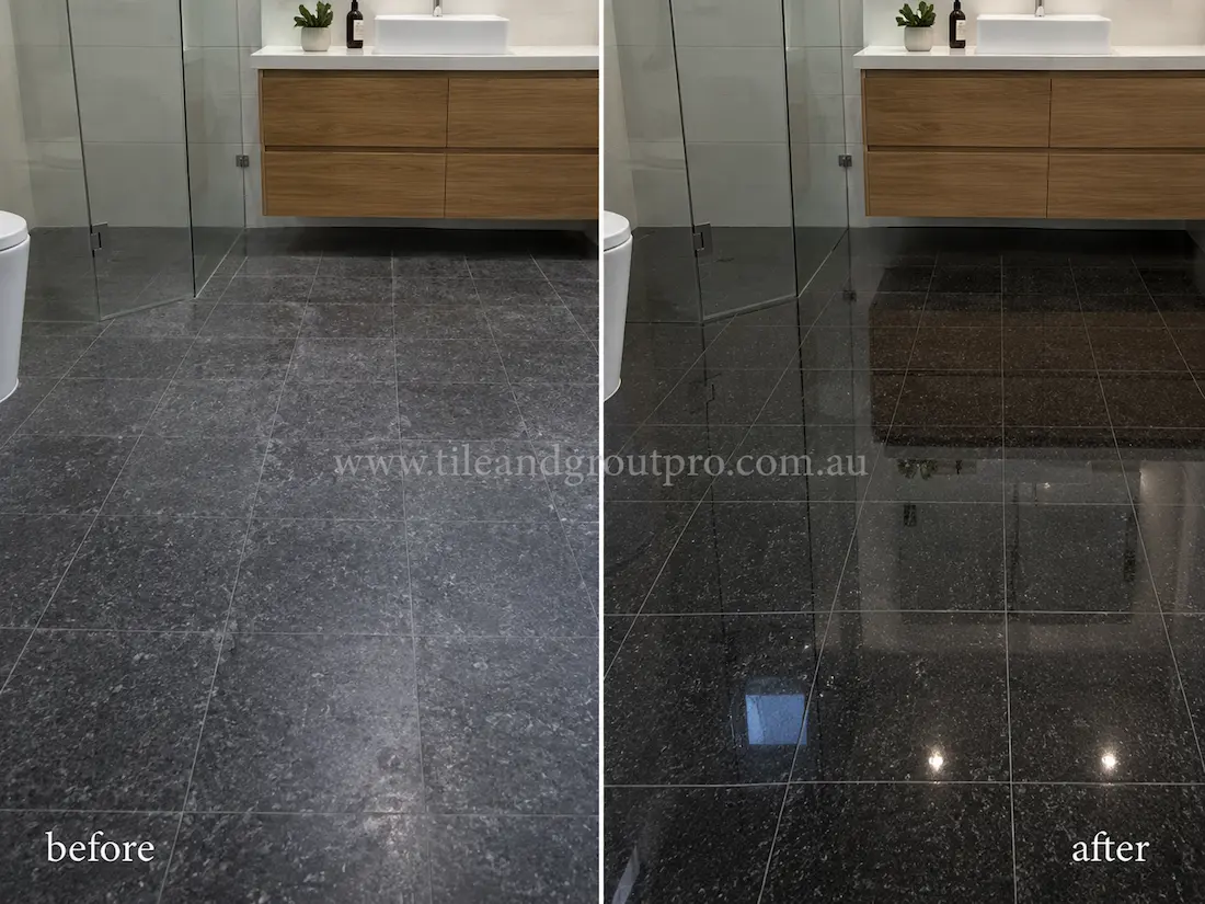 Before stone polishing, the black granite bathroom floor tiles appeared dull and uneven with reduced gloss near the glass shower enclosure and floating timber vanity.