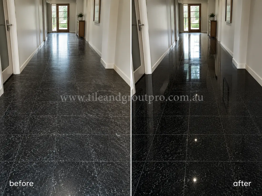 Before stone polishing, the black granite hallway floor tiles looked worn and low-sheen with visible surface haze in a long residential corridor with white walls and natural light from glass doors.