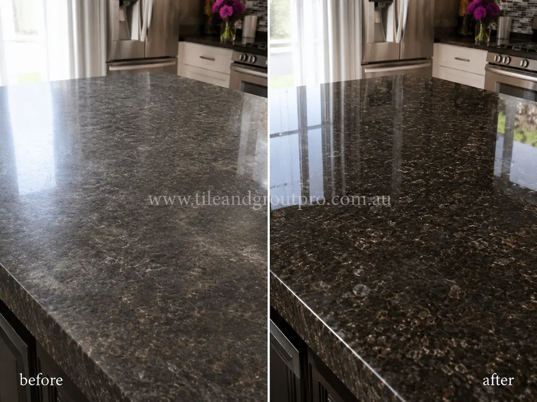 Large black granite kitchen island bench with visible surface haze, light scratching, and reduced shine before professional stone resurfacing and polishing.