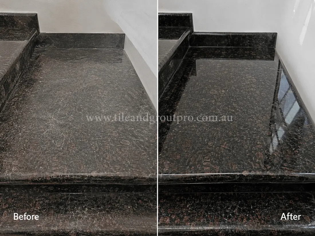 Black granite stair landing and step surfaces showing wear, scratches, and a faded finish before professional stone resurfacing and polishing.
