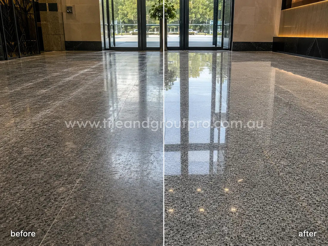 Commercial lobby granite floor before grinding, featuring dull polished stone tiles, visible wear patterns, scratches, and low shine near the entrance doors.