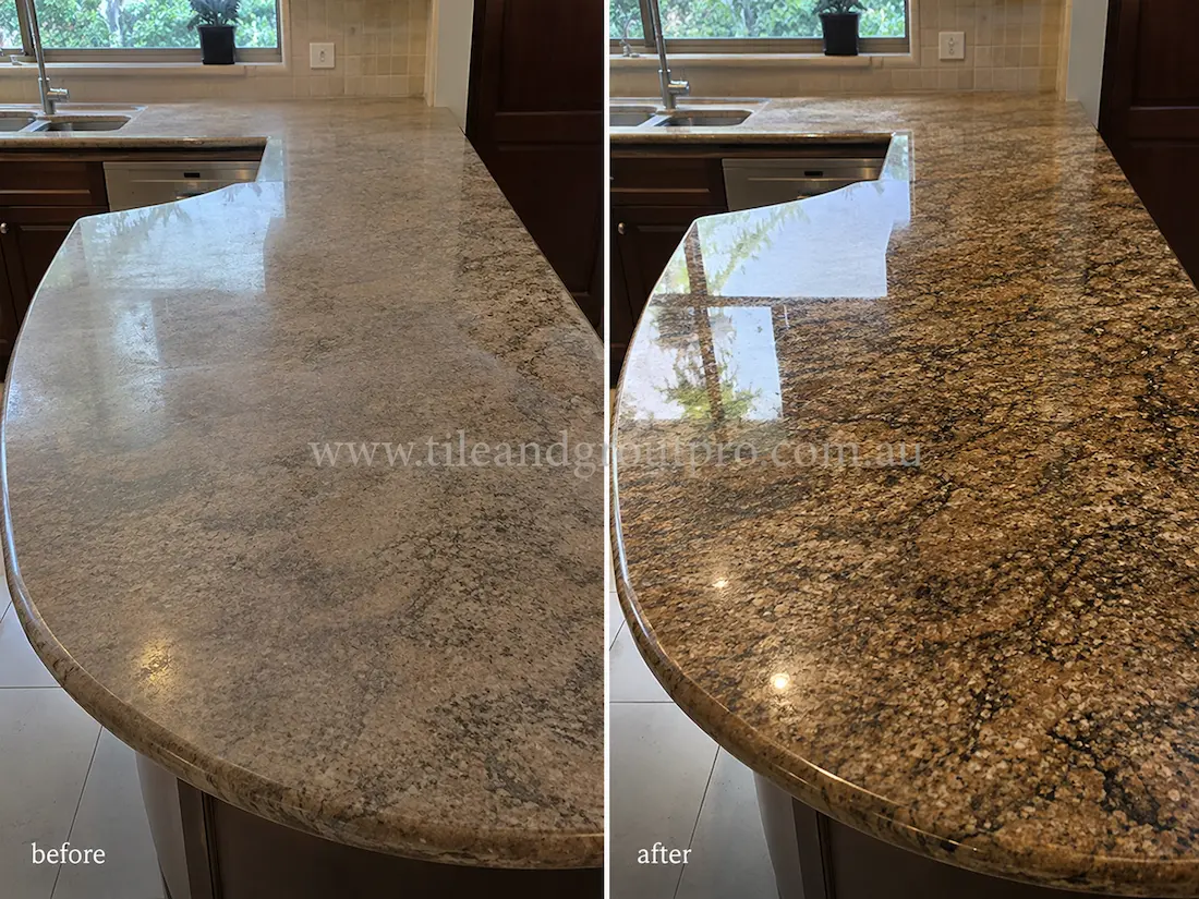 Before tile renewal, the granite kitchen benchtop had a faded finish, visible dull spots, and reduced clarity across the curved countertop surface.