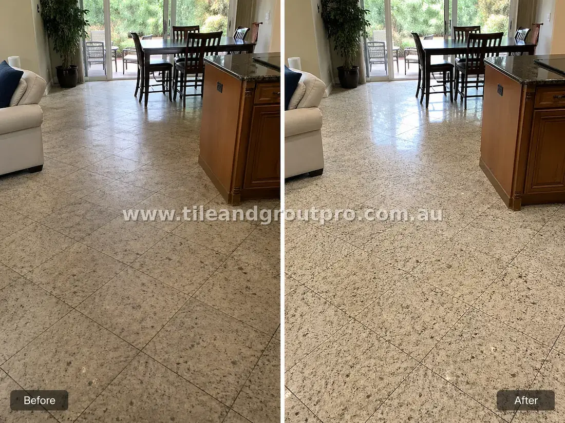 Granite natural stone floor tiles in a living and dining area showing dull surface, embedded dirt, and dark grout lines before tile and grout cleaning
