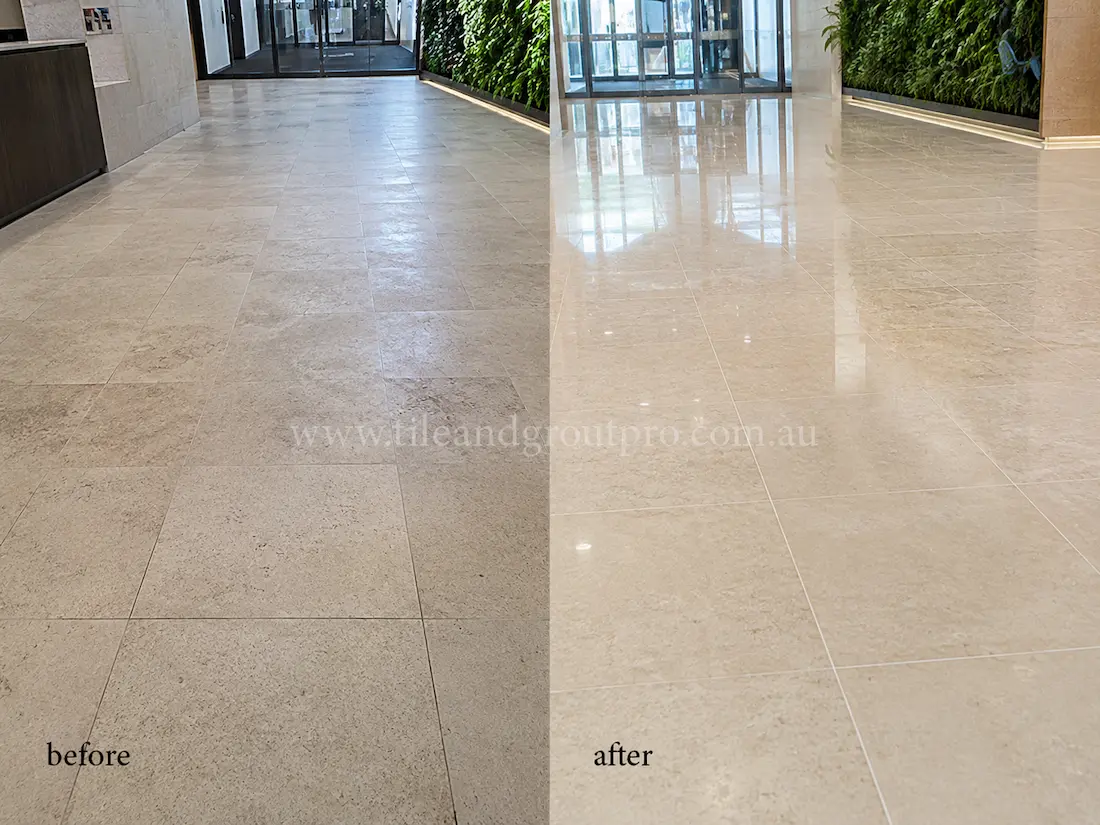 Cream limestone lobby floor in a commercial entrance area with visible wear and faded surface before stone polishing restoration.