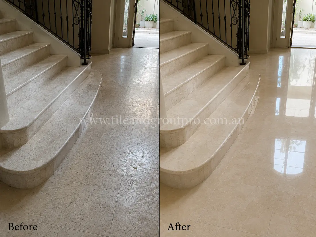 Before tile renewal, the marble staircase and entry floor appeared worn and low in shine with visible foot traffic and reduced clarity near the stairs.
