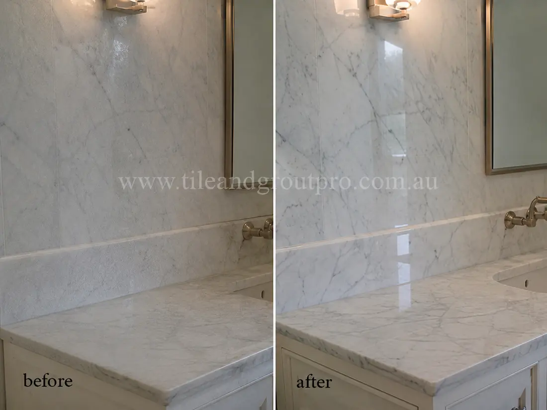 White marble bathroom vanity countertop and splashback with etched finish and low shine before stone polishing restoration.