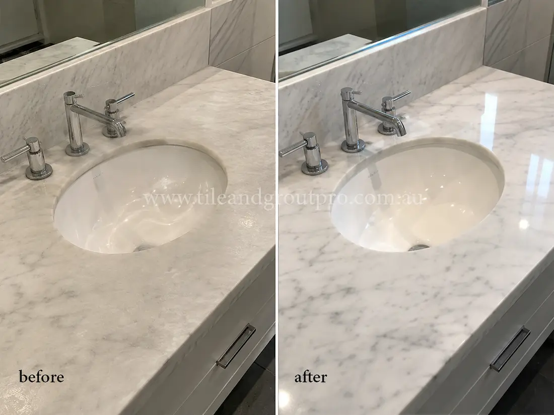 White marble bathroom vanity countertop with cloudy surface and reduced shine before marble stone polishing and restoration service.