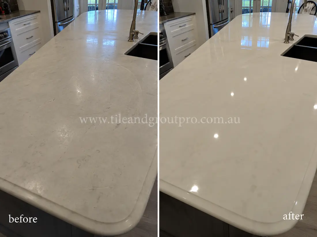 White marble kitchen island countertop before and after scratch removal, showing etched and scratched marble surface restored to a glossy polished finish.