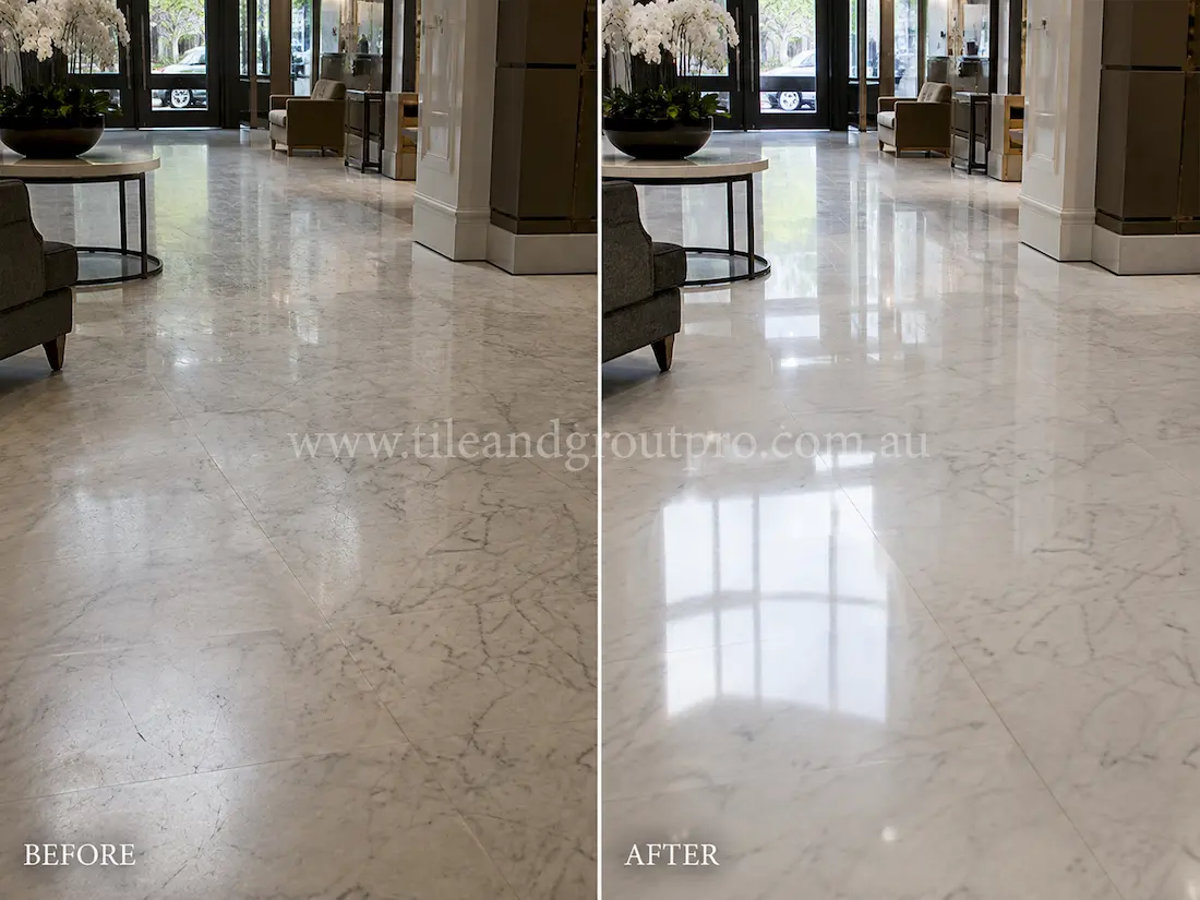 Commercial lobby with large white marble floor tiles showing a worn finish, light scratches, and diminished reflectivity before tile resurfacing and polishing.