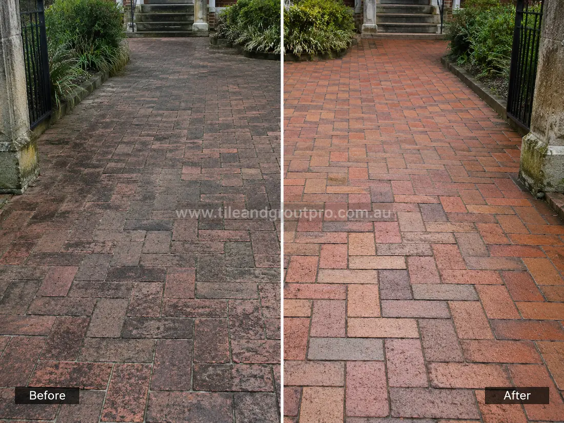 Outdoor garden pathway with herringbone brick pavers before sealer stripping, featuring dark sealer build-up, weathered brick surfaces, and patchy staining along the entrance path.