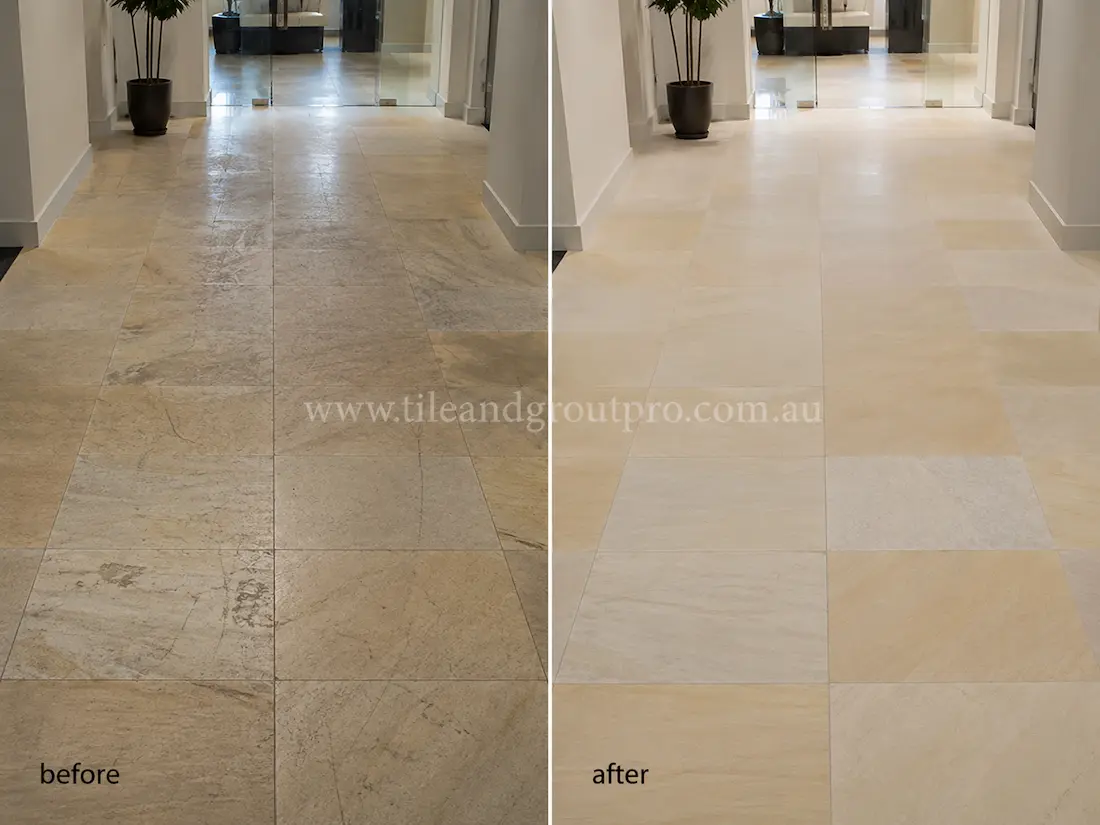 Commercial hallway with large-format cream sandstone floor tiles showing discoloration, dullness, and wear before professional sandstone tile resurfacing.