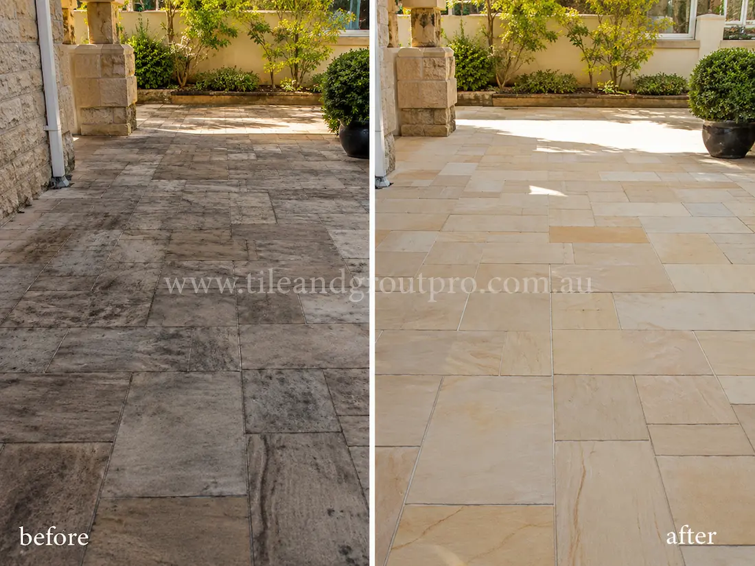 Before tile renewal, outdoor sandstone courtyard pavers appeared faded and heavily marked with black staining, dirt buildup, and uneven colouring in a residential patio entertaining area.