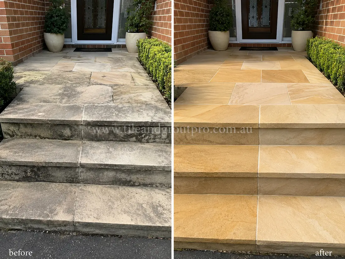 Before tile renewal, sandstone entry steps and porch tiles at a residential front entrance displayed dark staining, faded stone surfaces, and accumulated grime across the natural stone treads and landing.