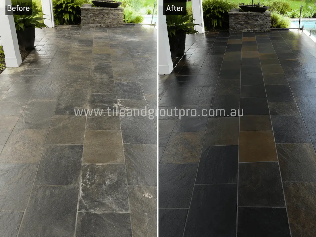 Before slate tile resurfacing, this covered outdoor patio features dark slate floor tiles with weathering, faded colouring, surface hazing, and loss of natural stone definition across the entertaining area.
