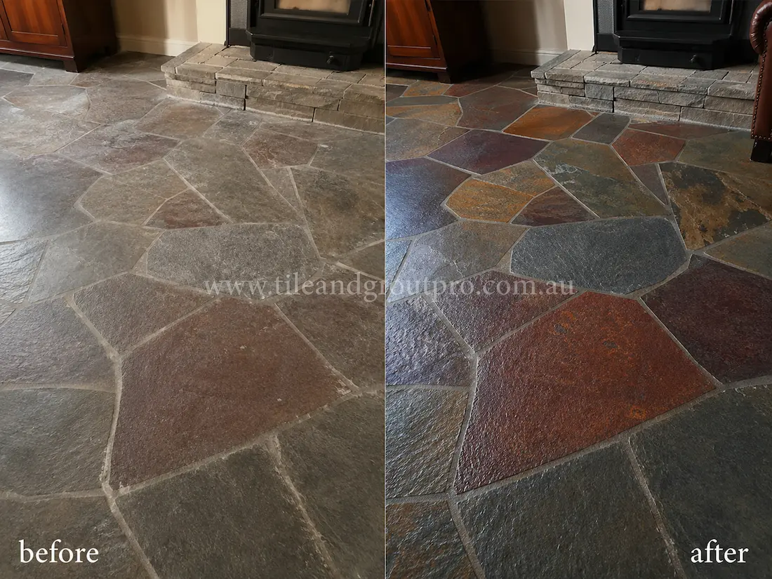 Before tile renewal, multicoloured slate floor tiles around a living room fireplace appeared dull and weathered, with muted tones, light surface residue, and worn natural stone texture.