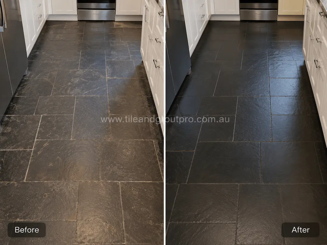 Before slate tile resurfacing, this kitchen floor showcases dark slate tiles with worn surfaces, faded tones, light etching, and a dull finish caused by daily household traffic.