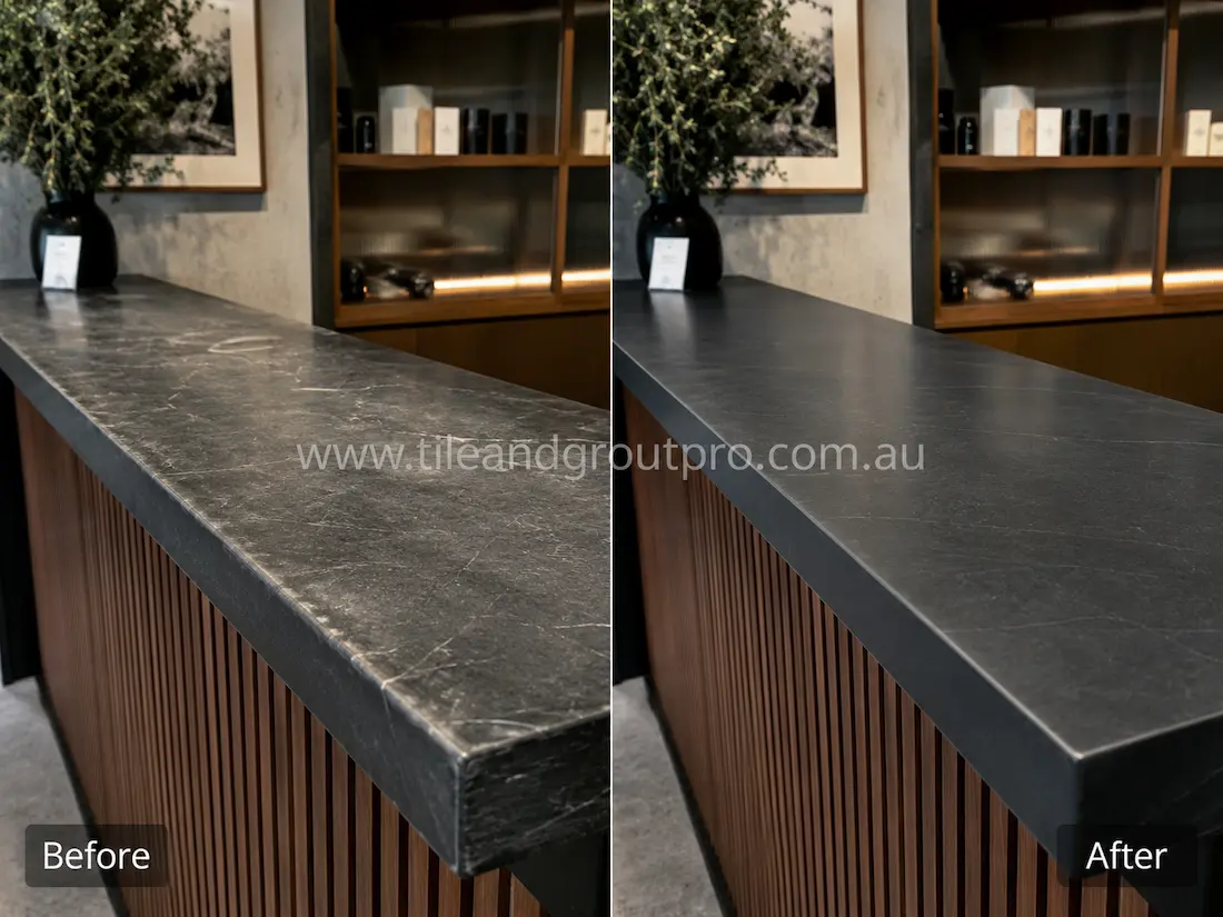 Before and after tile resurfacing of a soapstone-look reception countertop, showing a worn dark stone surface with light scratches and etching restored to a smooth, uniform finish with subtle white veining.
