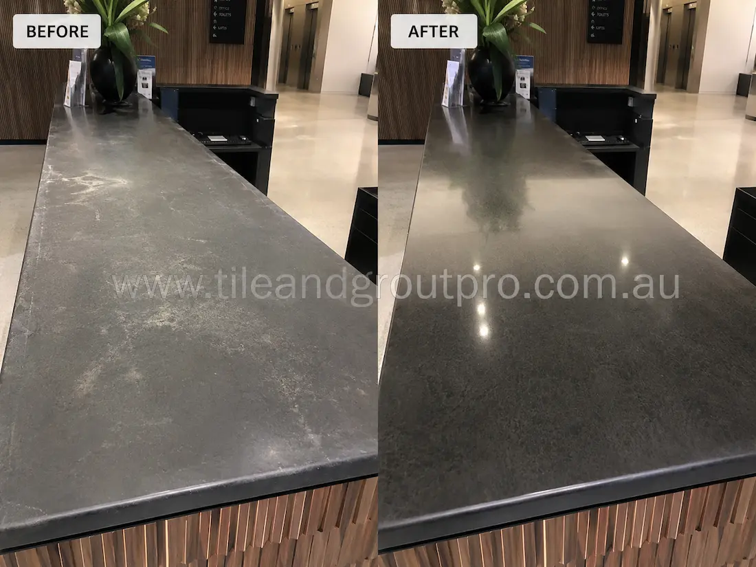 Before-and-after stone polishing of a soapstone office counter benchtop, showing a worn and faded gray surface before polishing and a restored, smooth dark finish after.