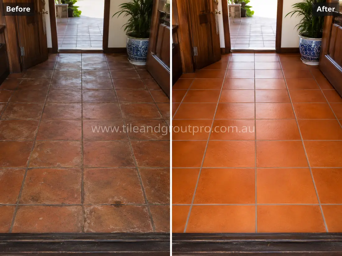 Before tile renewal, terracotta entryway floor tiles near an exterior doorway showed dullness, staining, surface wear, and uneven colour caused by heavy foot traffic and accumulated grime.