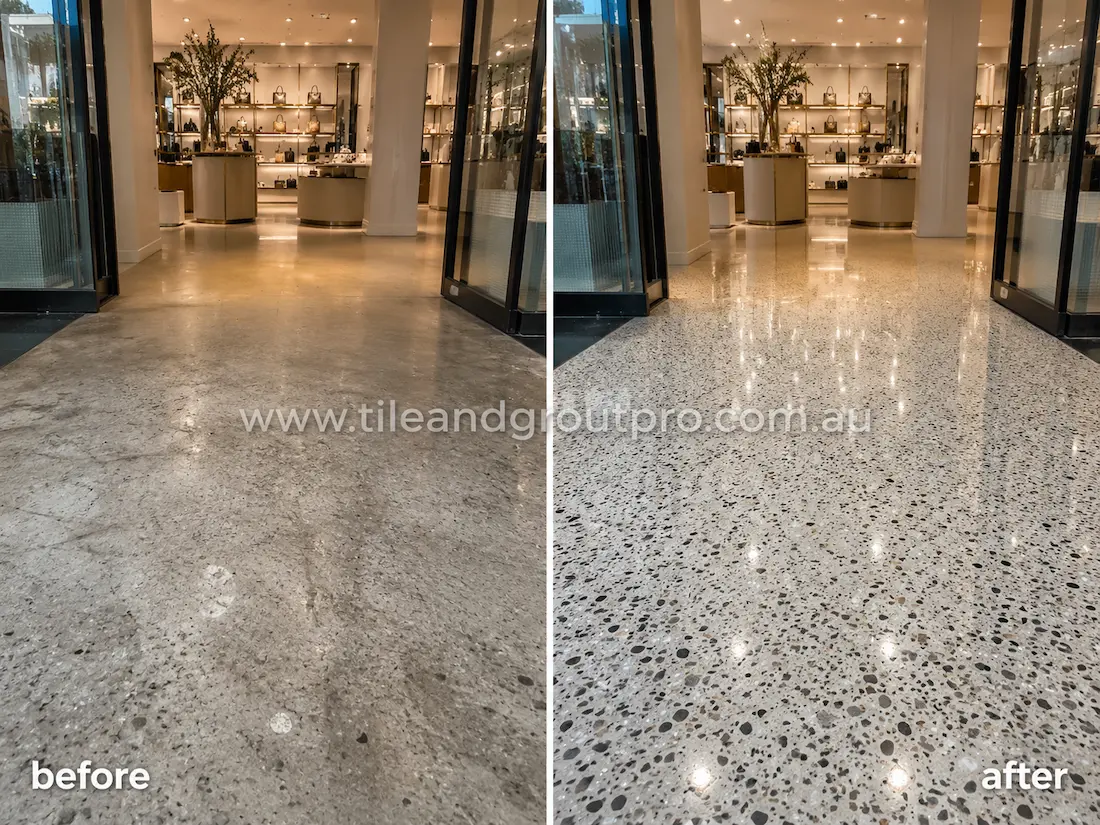 Retail store terrazzo floor before grinding, showing worn exposed aggregate flooring with dullness, scratches, and uneven sheen near the shop entrance and display area.