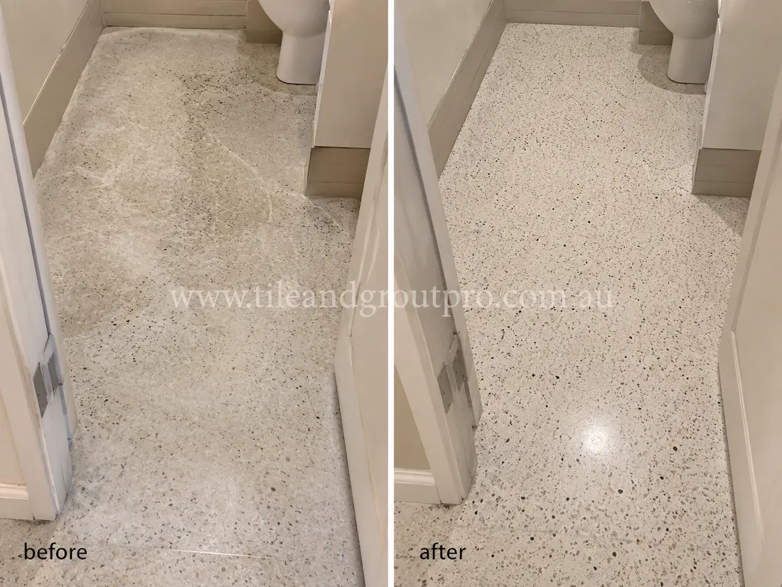 Residential bathroom terrazzo floor with visible staining, dullness, surface wear, and embedded dirt before professional terrazzo tile resurfacing and polishing.