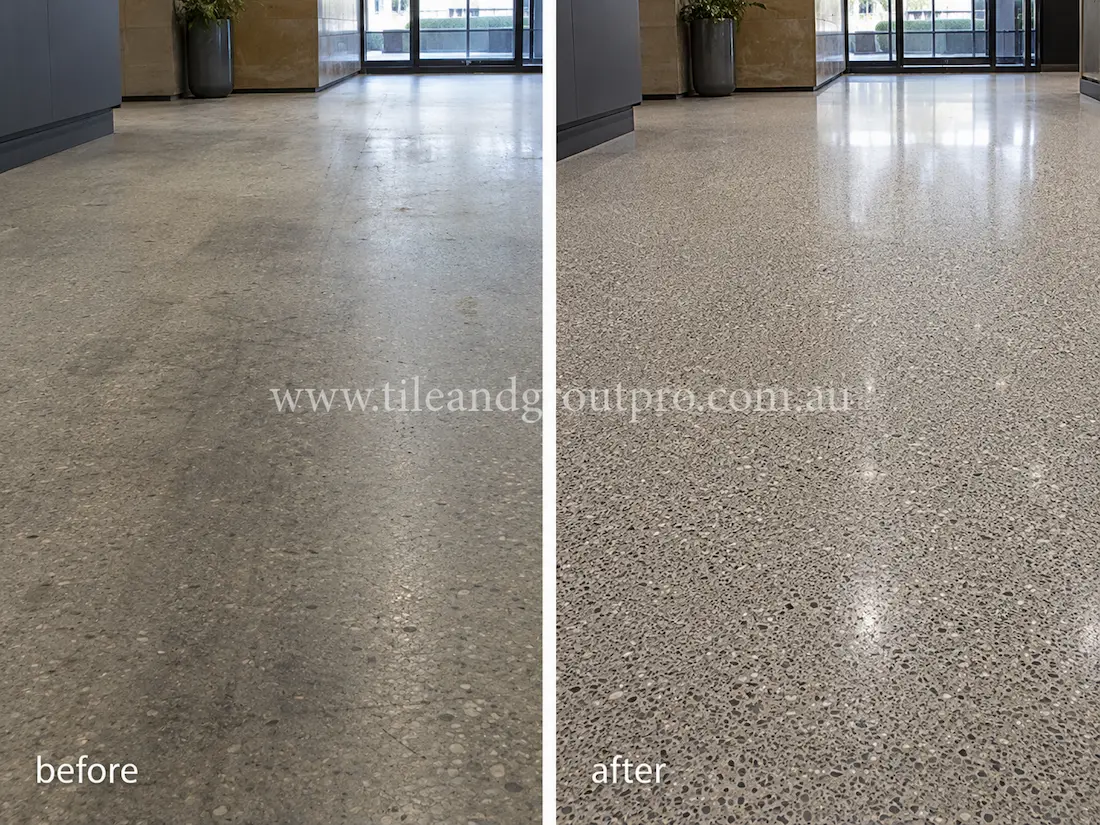 Commercial lobby terrazzo floor with heavy foot-traffic wear, scratches, and reduced reflectivity before terrazzo tile resurfacing and polishing.