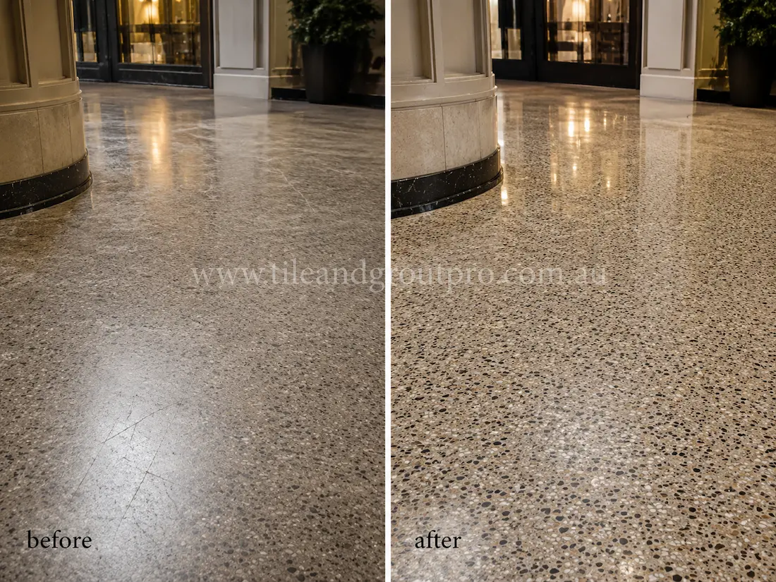 Retail store terrazzo floor near a glass storefront entrance, displaying scratches, scuff marks, and a faded finish before terrazzo tile resurfacing and restoration.