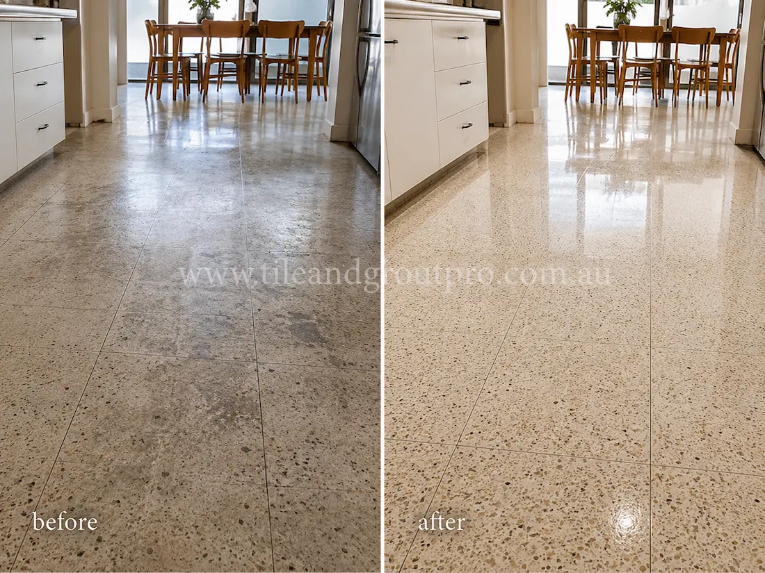 Open-plan kitchen and dining area with terrazzo flooring showing traffic wear, stains, and a faded finish before terrazzo tile resurfacing and shine restoration.