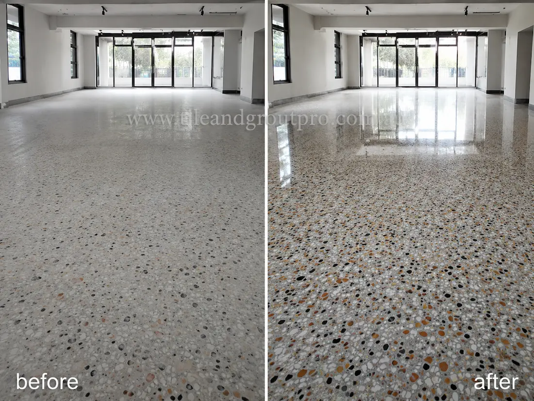 Before stone polishing, the terrazzo floor in a large open-plan commercial space appeared cloudy and low-gloss with subdued stone aggregate detail and minimal reflections from surrounding windows.