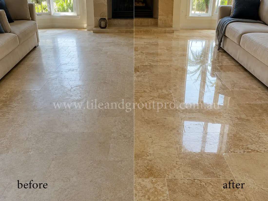 Before stone polishing, the light travertine living room floor tiles had a faded matte finish and visible wear in a lounge area with sofas, fireplace, and large windows.