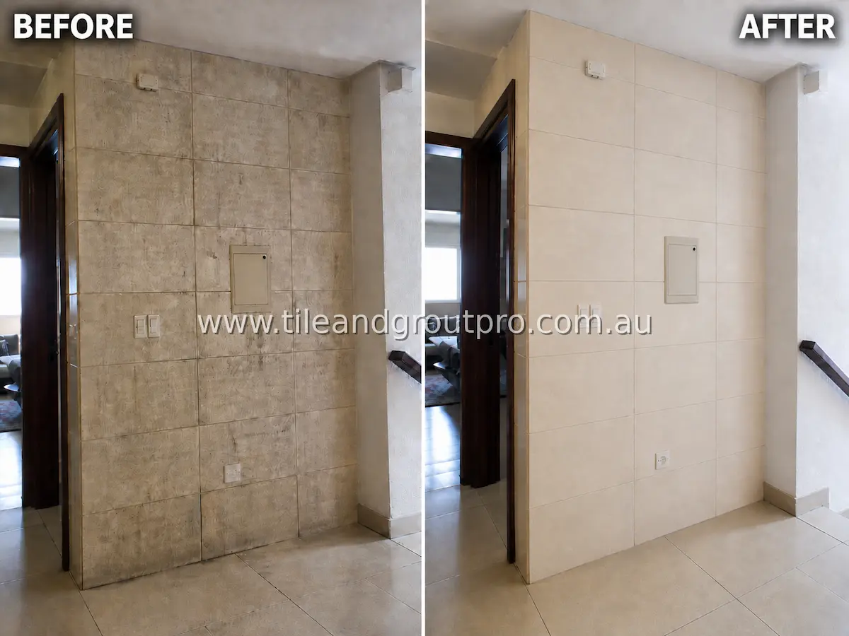 Staircase accent wall with large-format ceramic tiles covered in dirt, staining, and uneven discoloration before tile and grout cleaning service