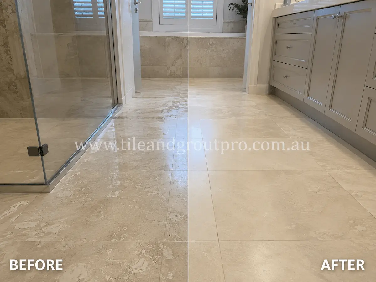 Before and after view of a bathroom limestone floor with etching, dullness, and surface wear restored through stone honing for a smoother matte finish.