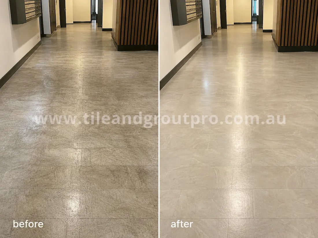 Commercial hallway with grey vinyl tiles before sealer stripping, featuring dull surface wear, patchy sealer residue, and uneven sheen in an apartment-style corridor.
